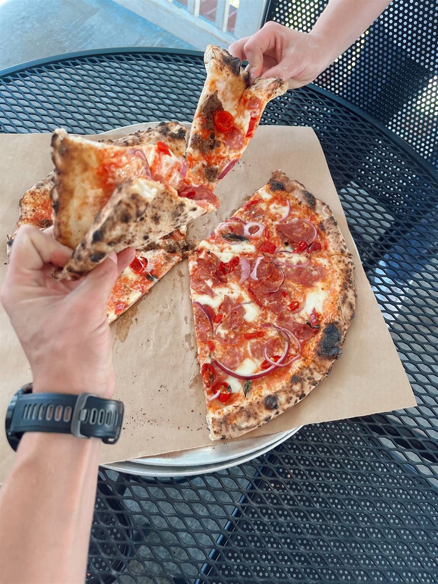 Pulling a slice of Neapolitan pizza