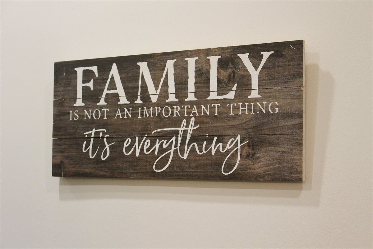A sign inside Pizzeria Lucca reading: family is not an important thing, it's everything