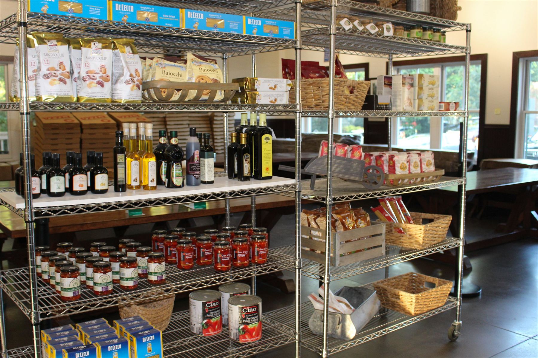 The Pizzeria Lucca market shelves stocked with imported pasta, olive oil, canned tomatoes and house-made sauces