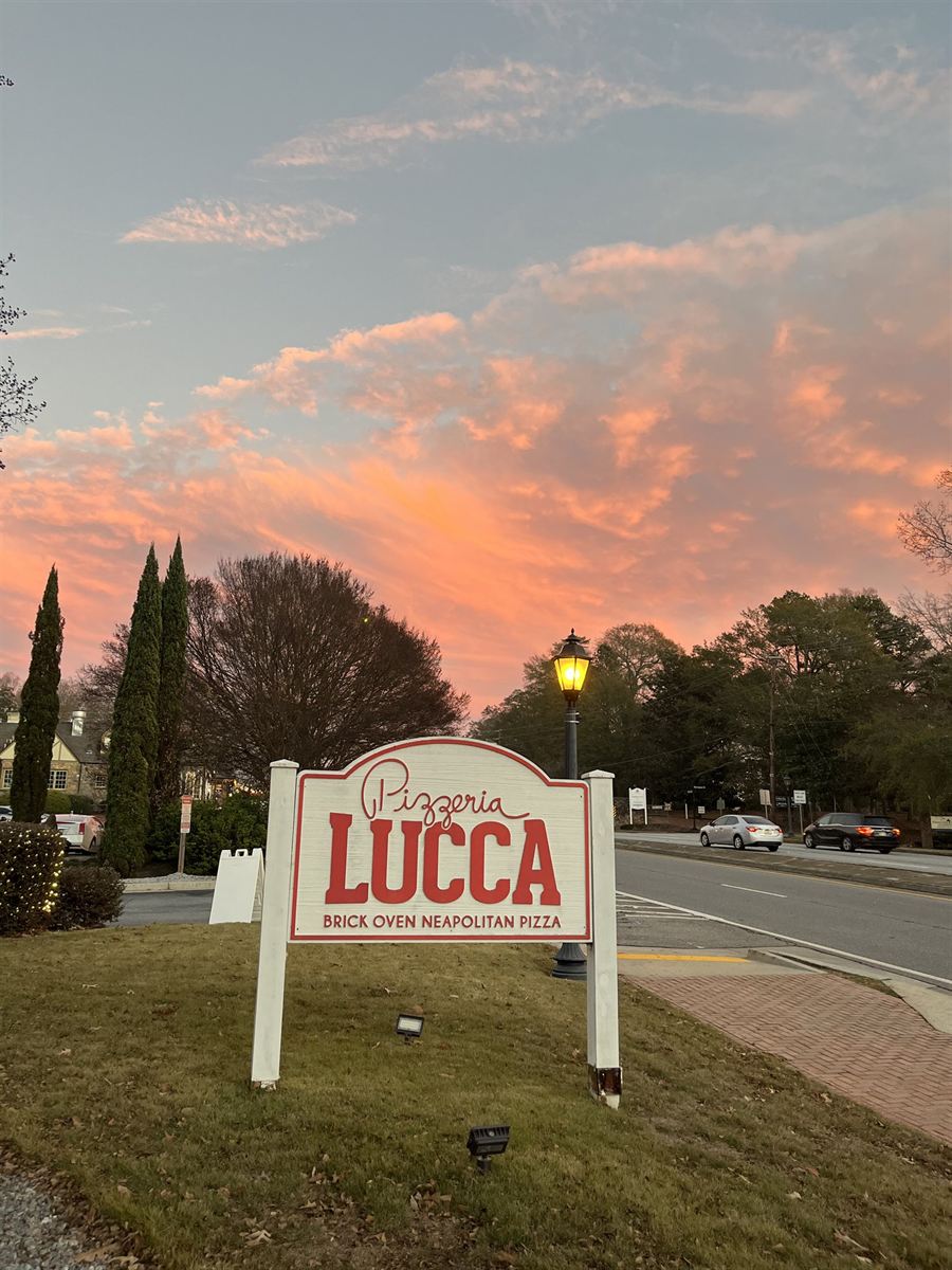 Pizzeria Lucca sign at dusk